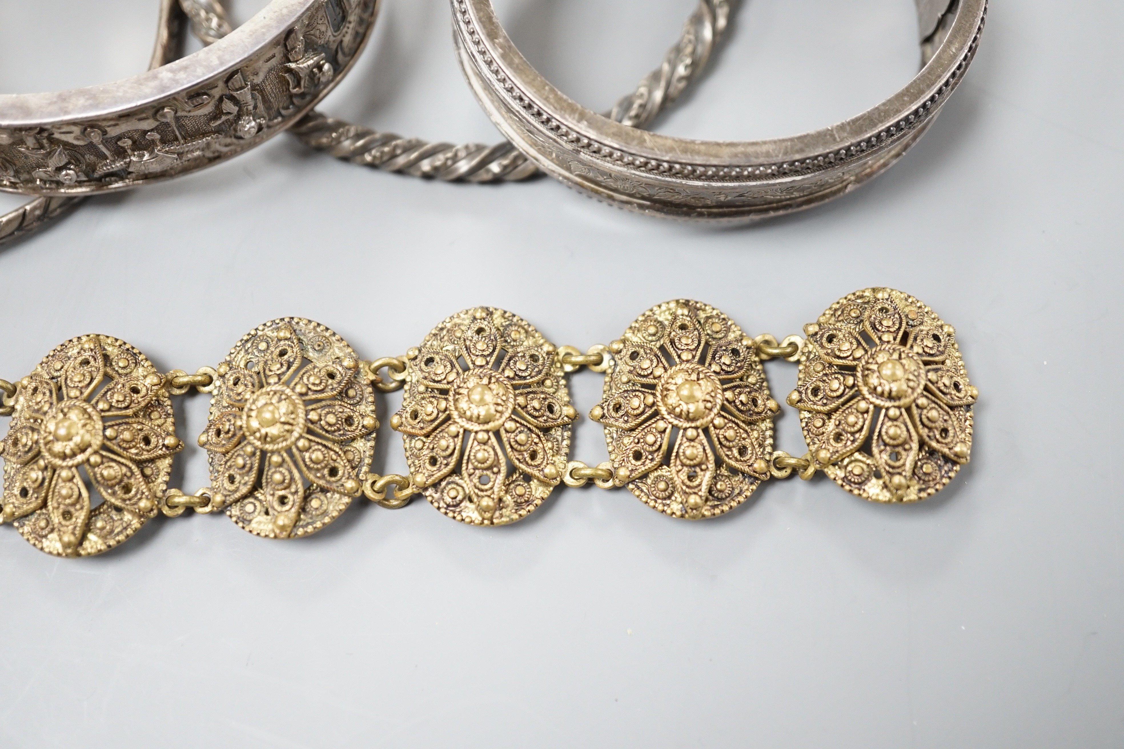 A Chinese white metal hinged bangle and five other items, including an engraved silver hinged bangle.